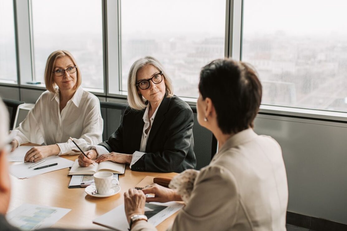 Business professionals engaged in a strategy meeting in a contemporary office. Daytime setting.